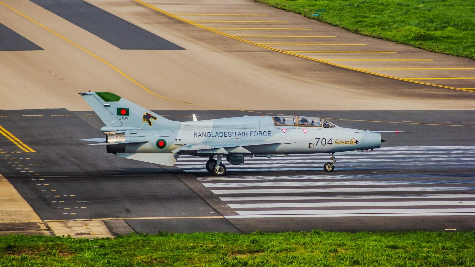 A fighter jet sitting on top of an airport runway