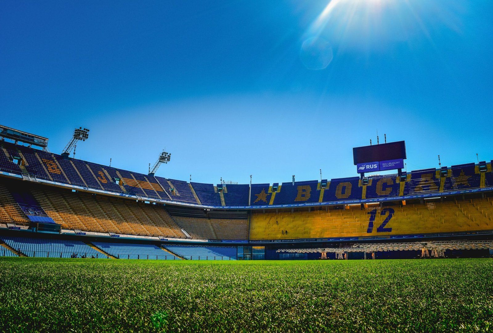 A stadium filled with lots of green grass