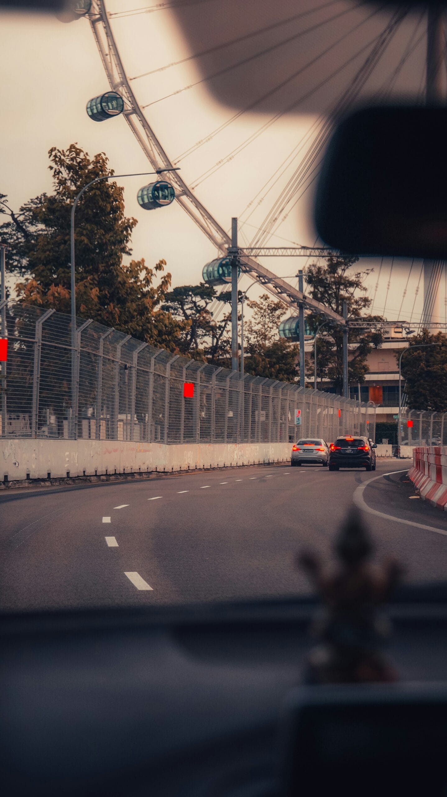 A view of a ferris wheel from inside a car