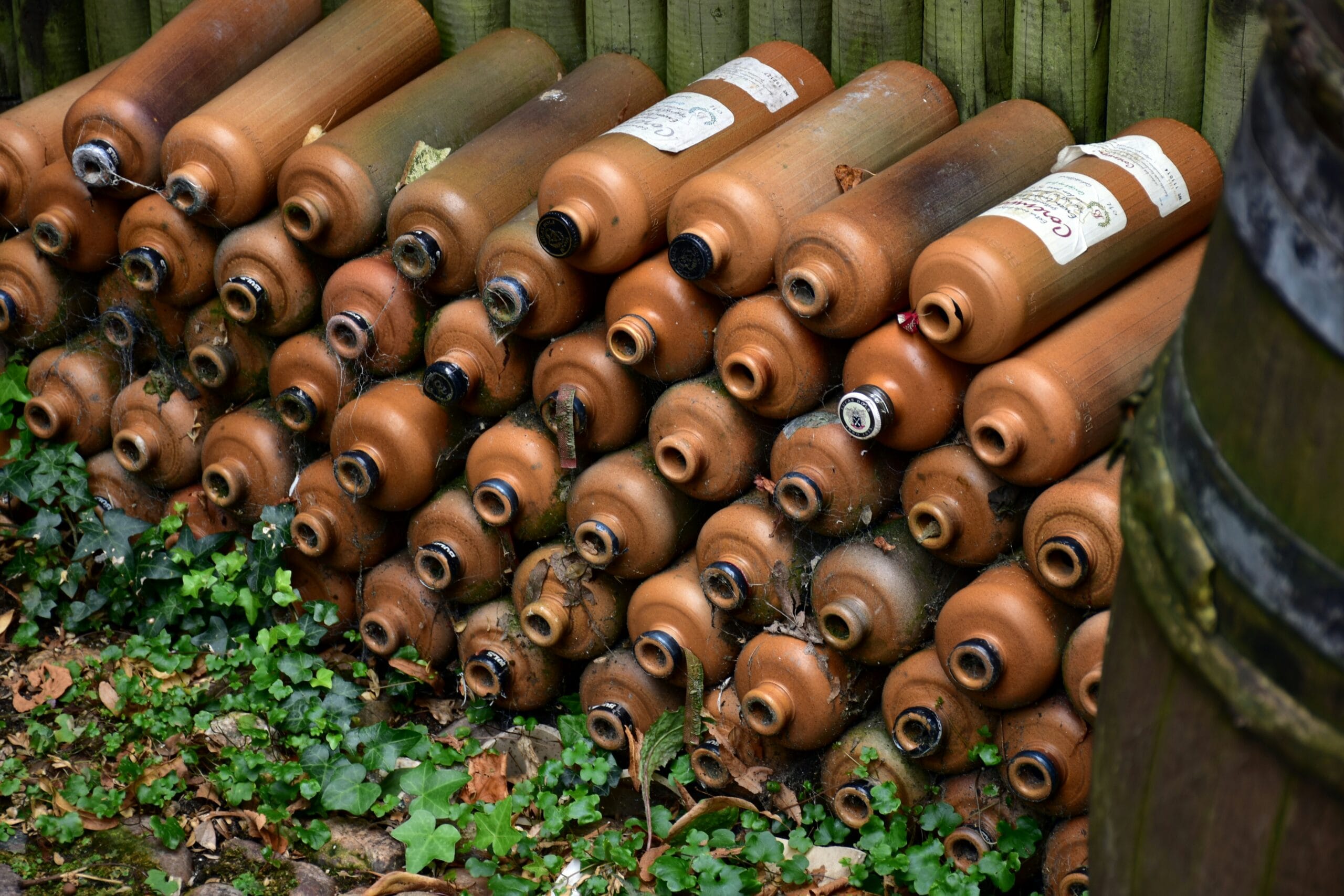 a bunch of brown vases sitting on the ground