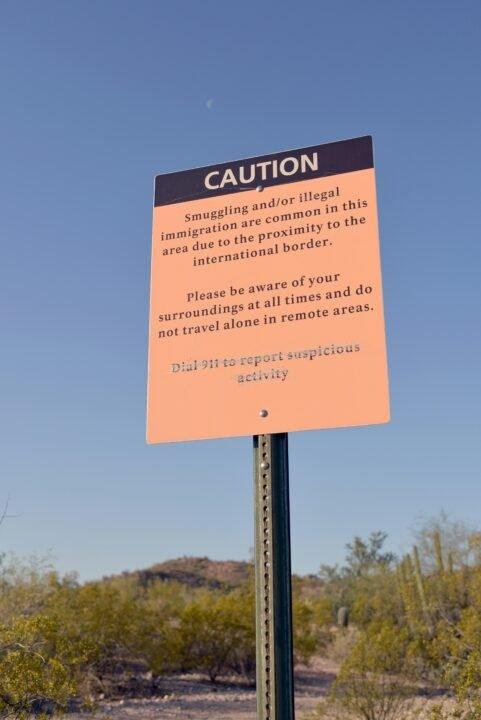 a caution sign in the middle of a desert