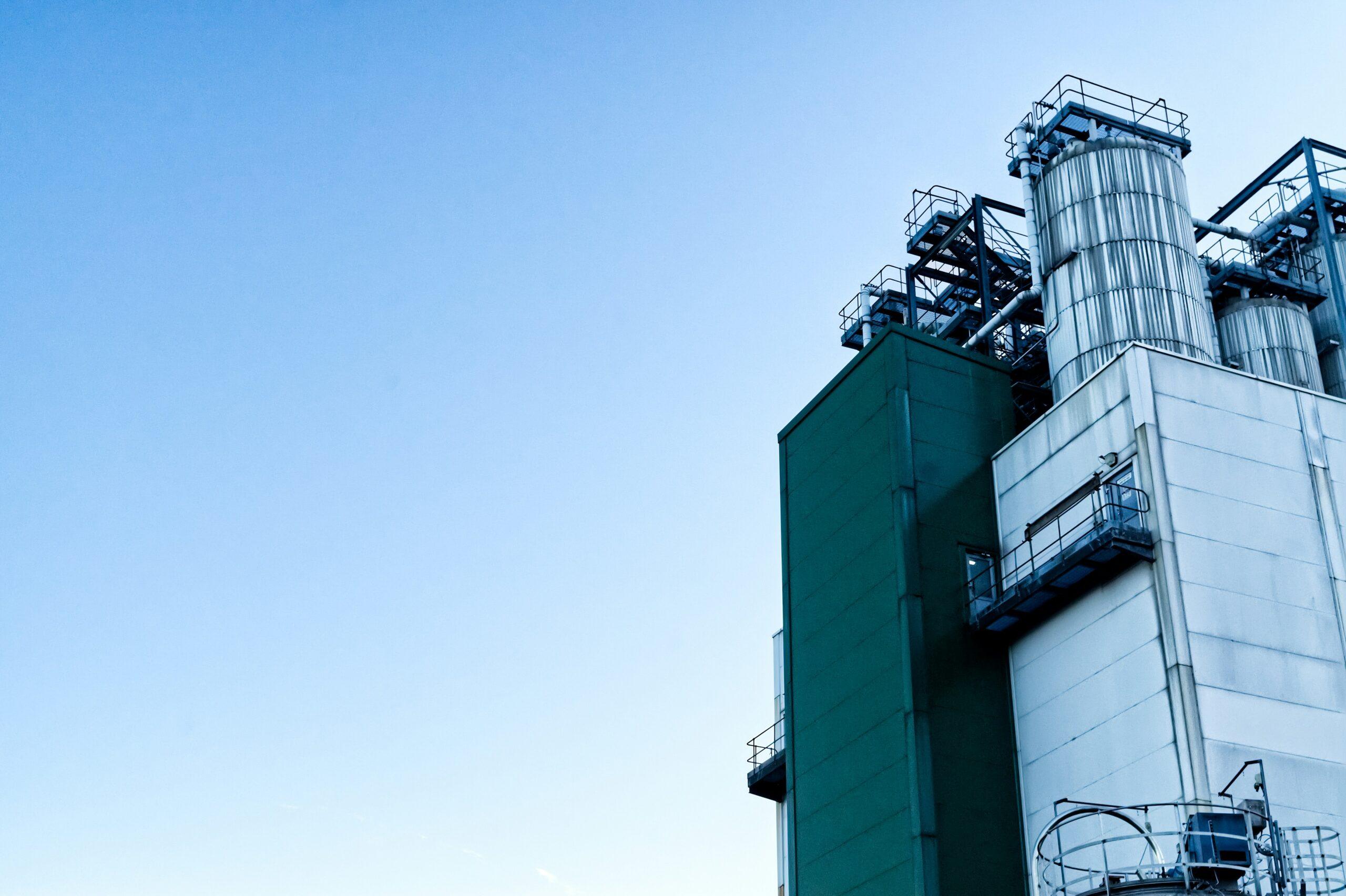 a factory building with a sky background