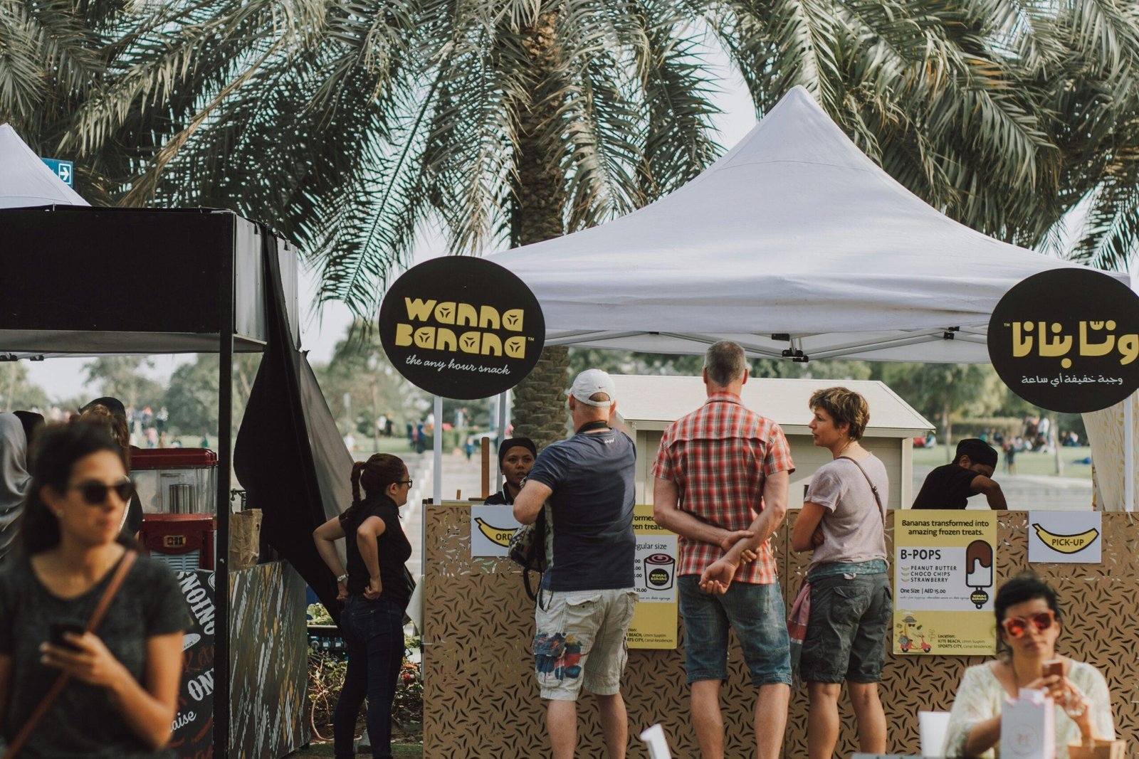 a group of people standing under a tent