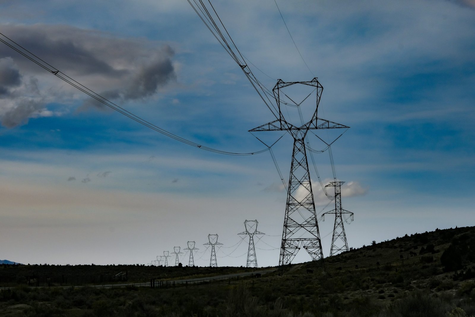 a high voltage power line in the middle of a field