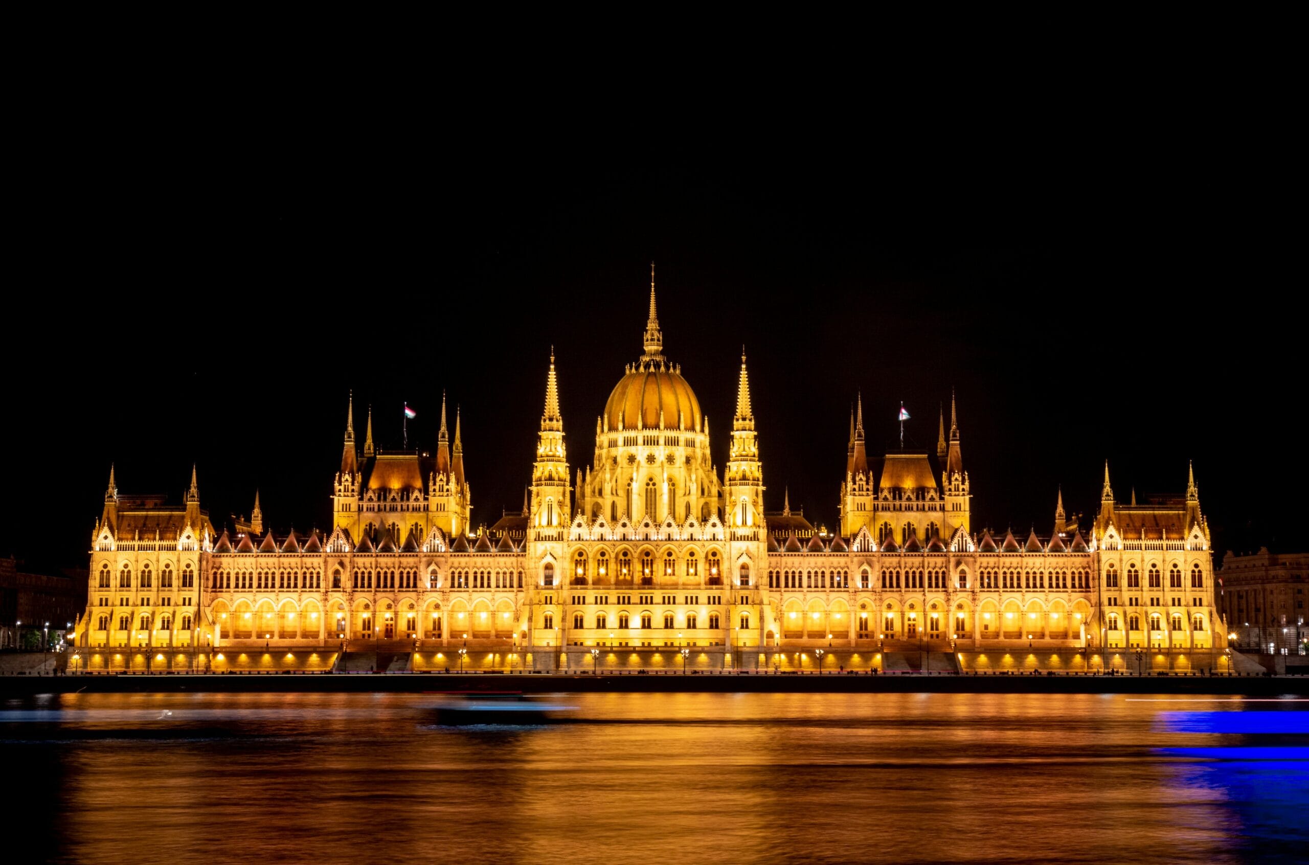 a large building lit up at night on the water