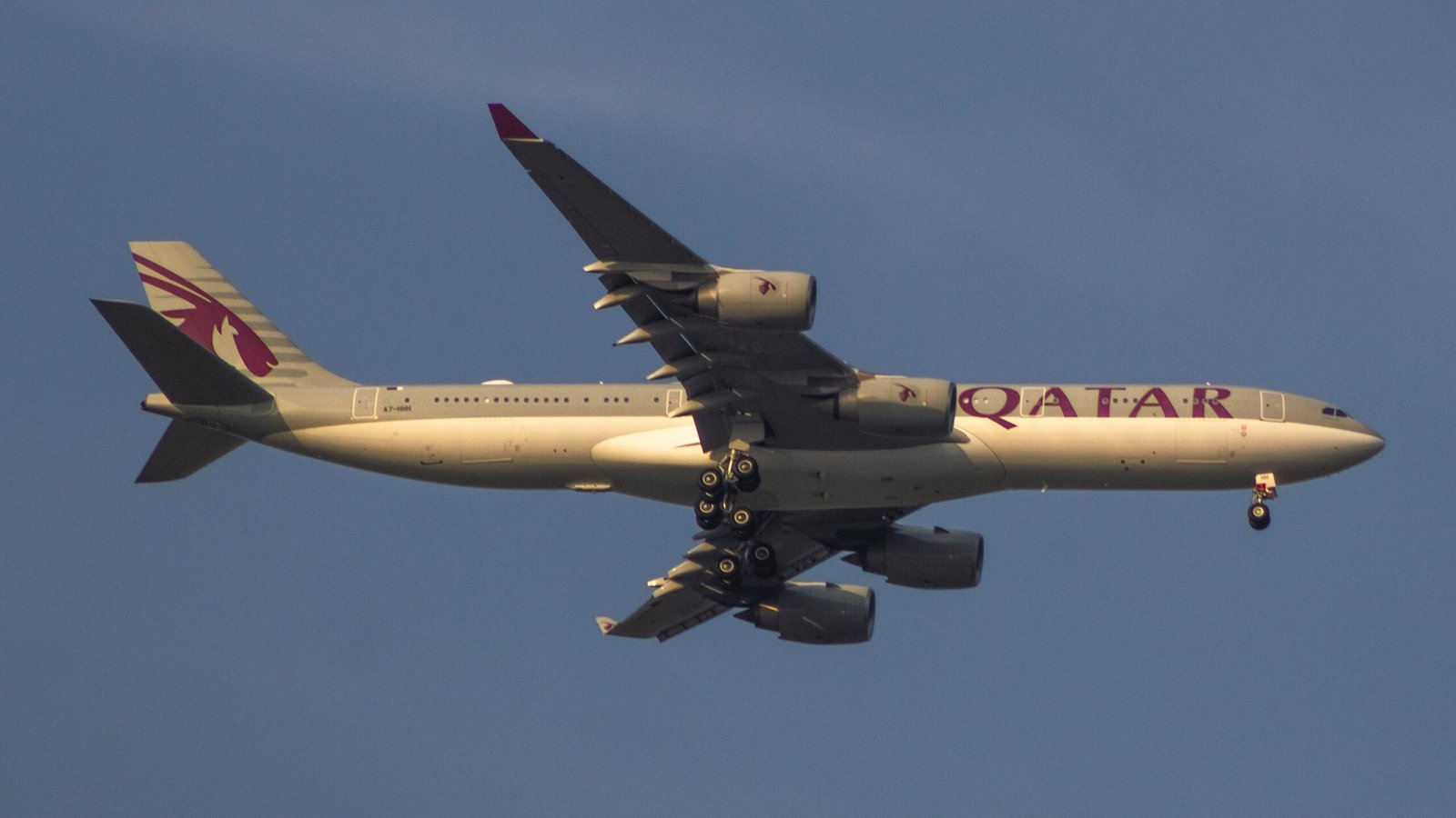 a large jetliner flying through a blue sky