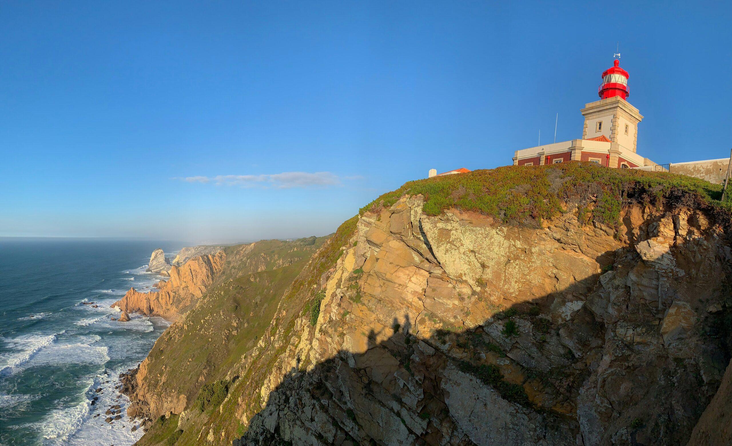 a lighthouse on a cliff overlooking the ocean