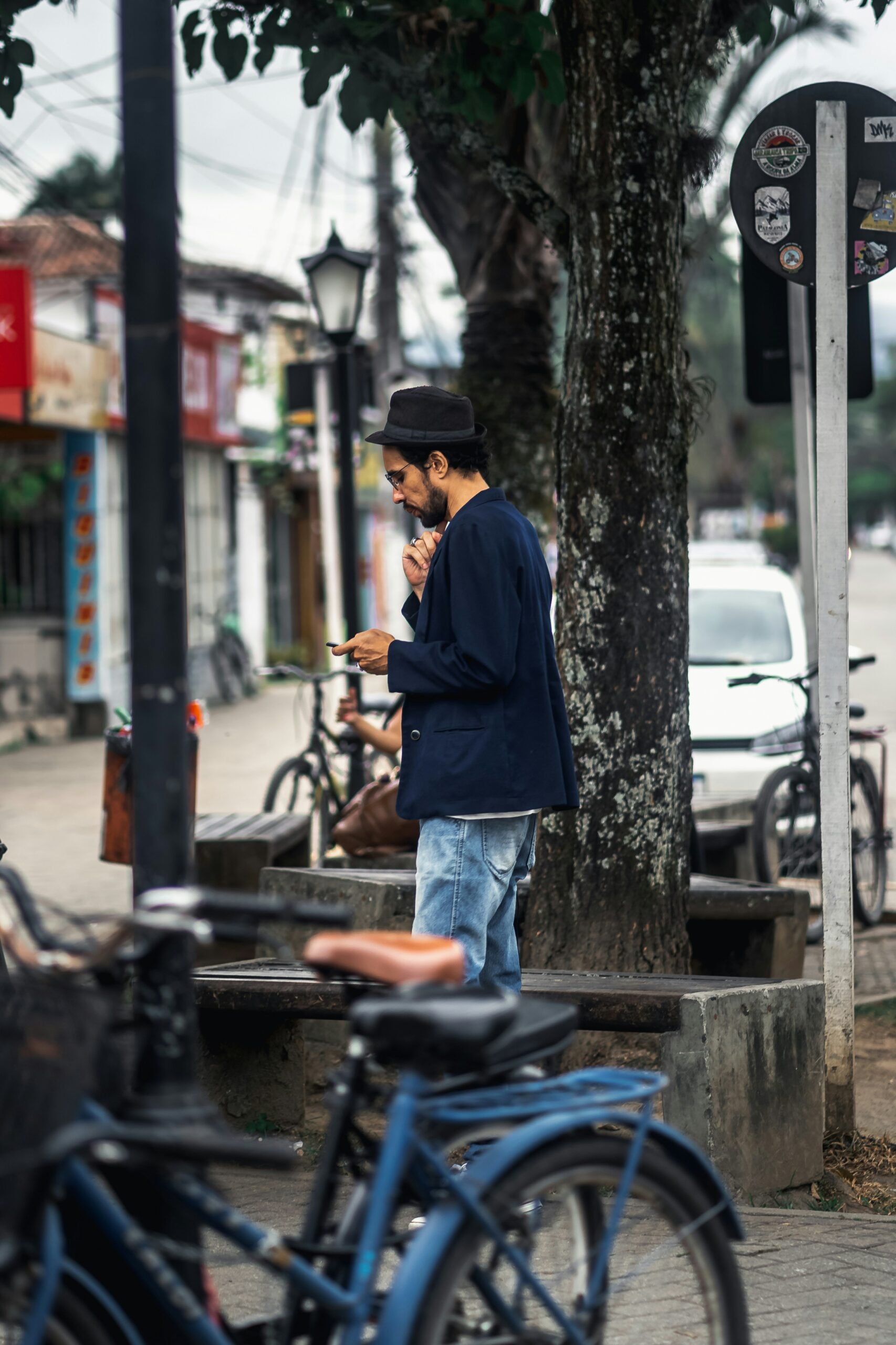 a man standing next to a bunch of parked bikes