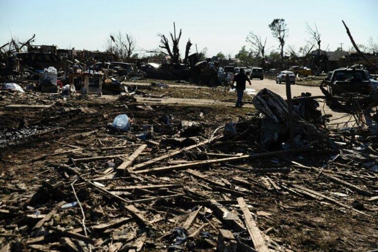 a pile of debris sitting on top of a dirt field