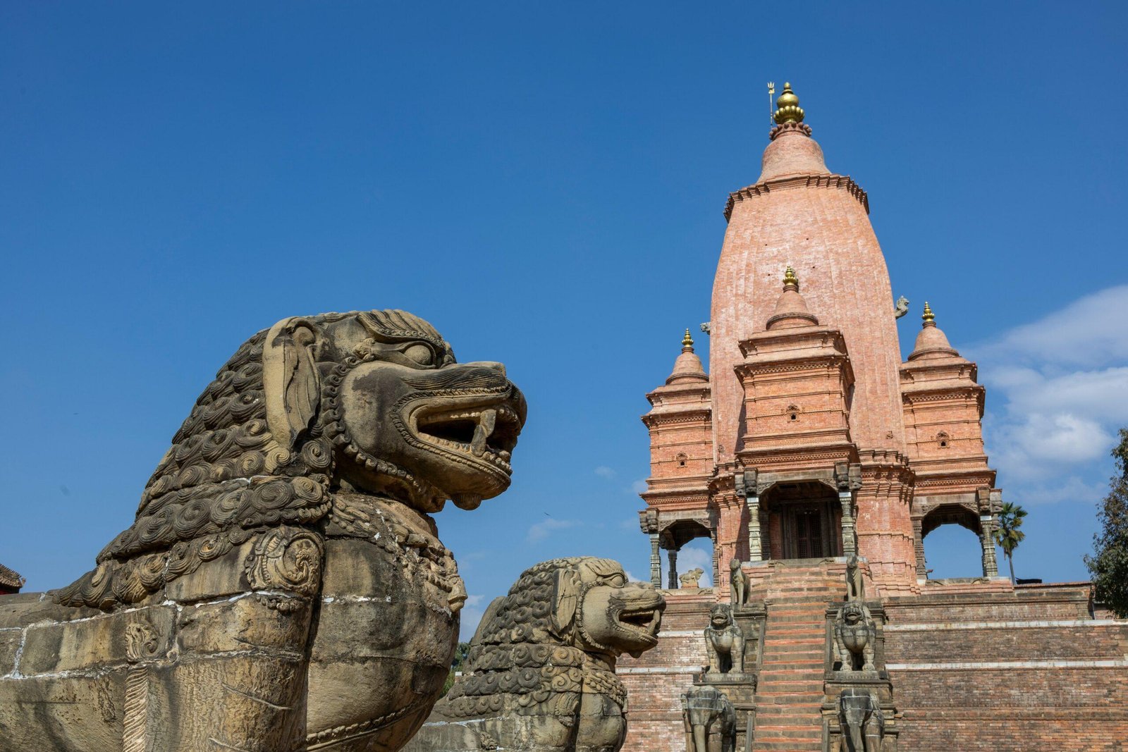 a stone lion statue in front of a building