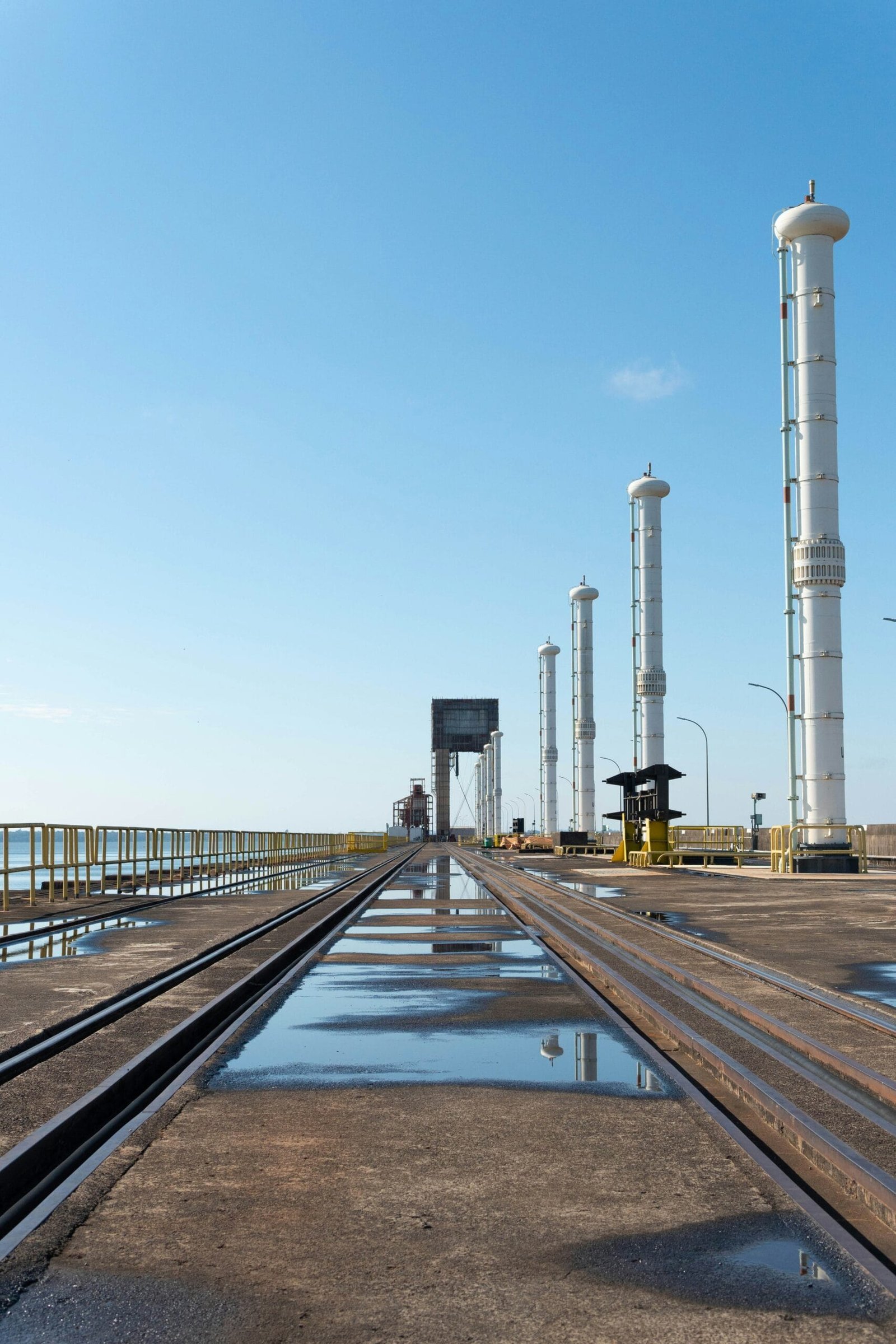 a train track running through a large industrial area