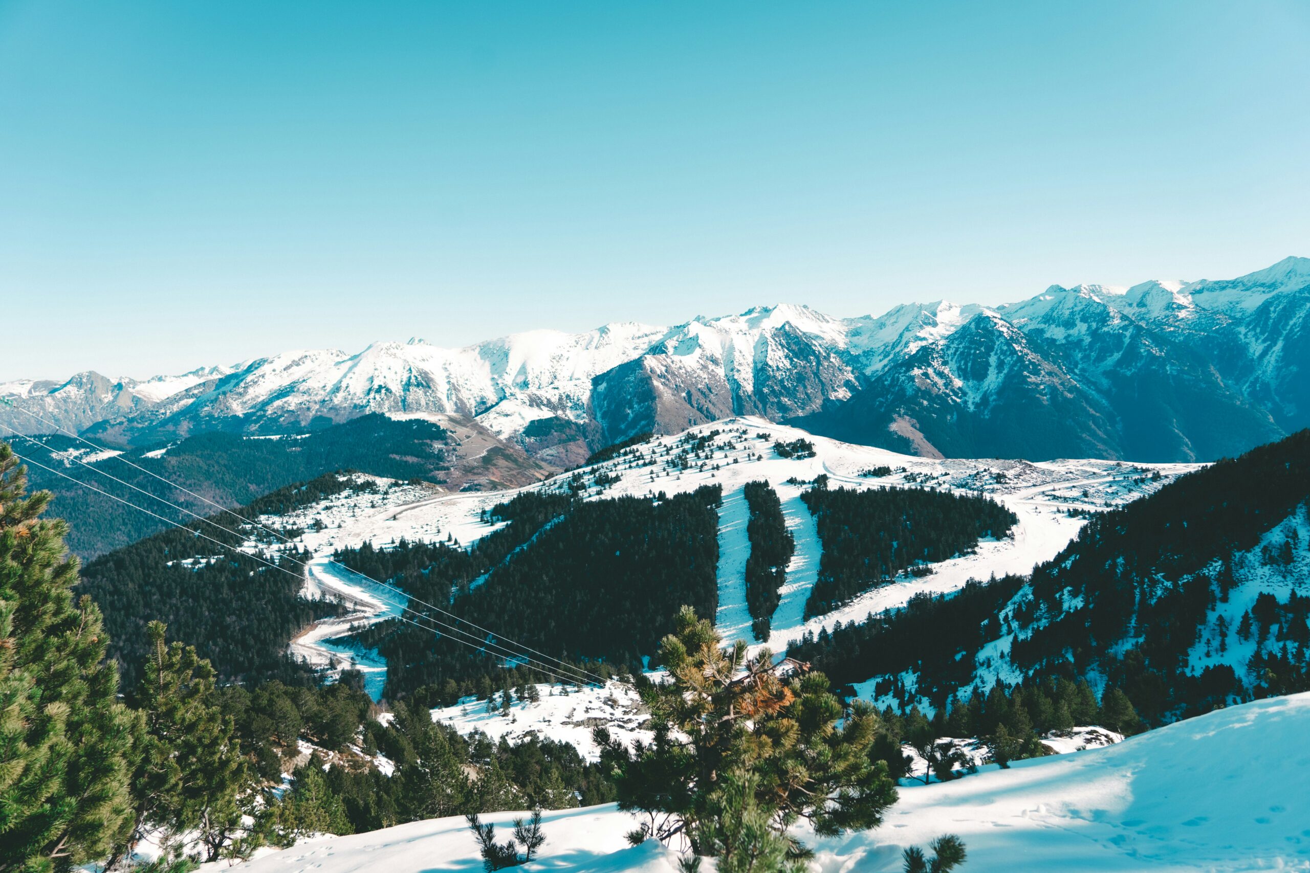 a view of a snowy mountain range with a river running through it