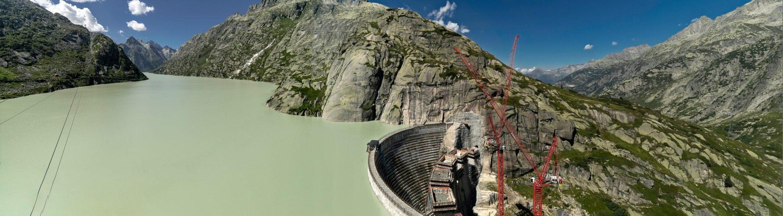 an aerial view of a dam in the mountains