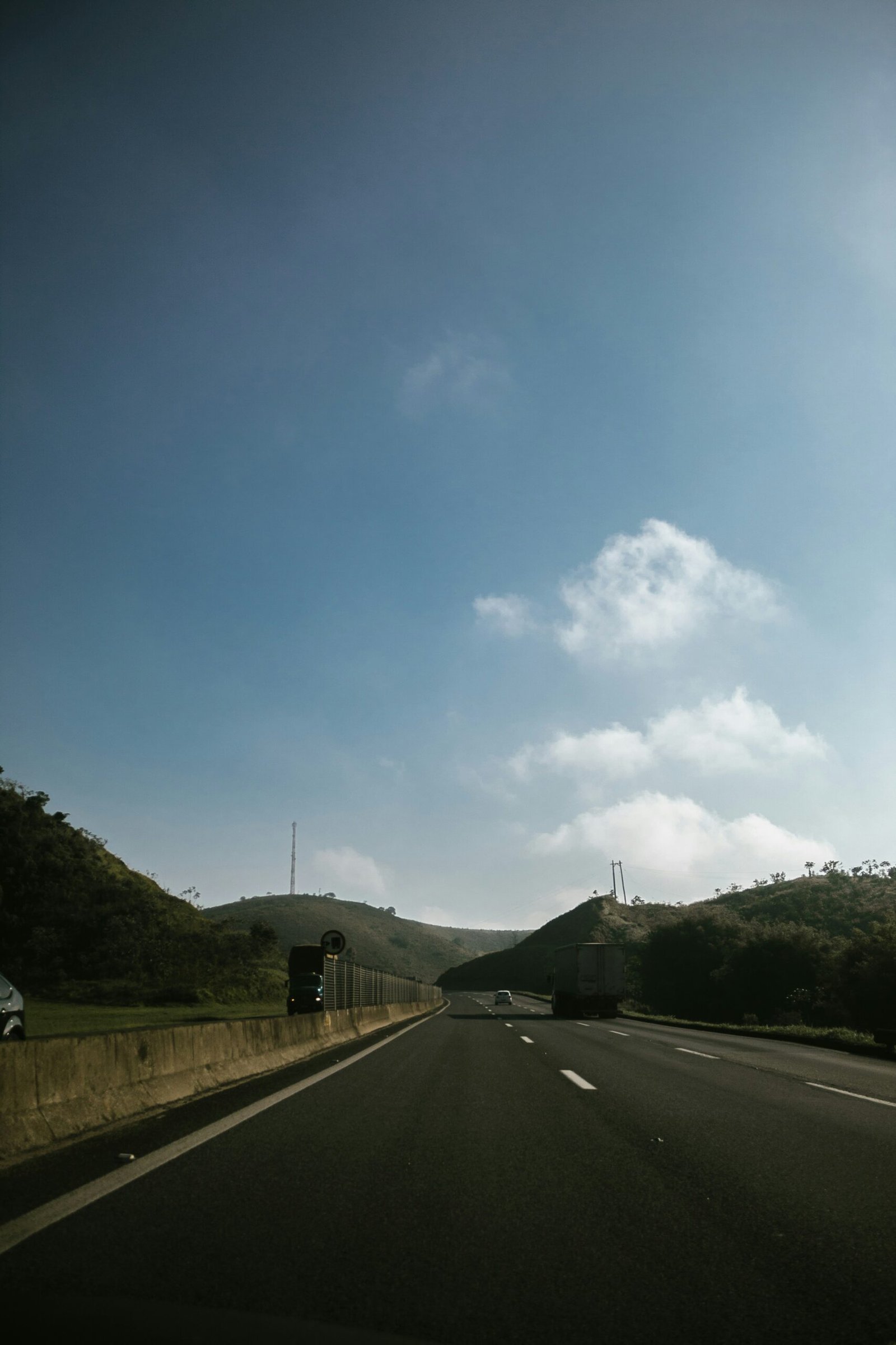 asphalt road under blue sky