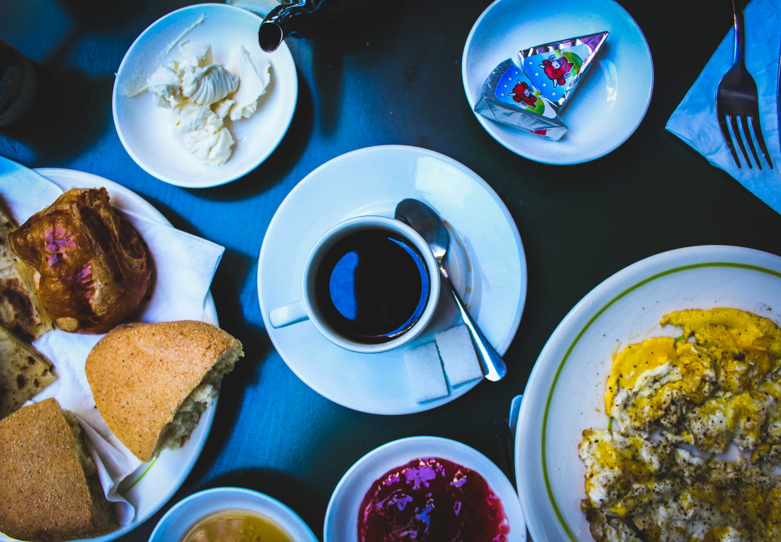 cooked foods on plate and black coffee