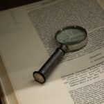 a magnifying glass sitting on top of an open book