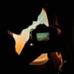 a person taking a picture of a plane window