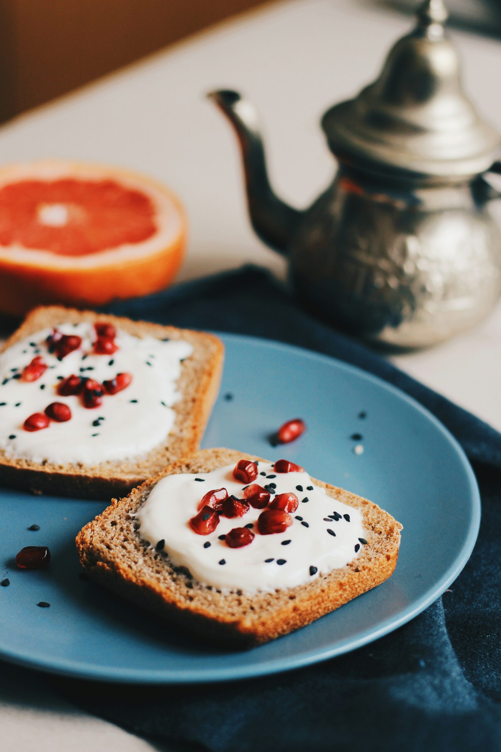 flatlay photography of spreaded bread beside teapot