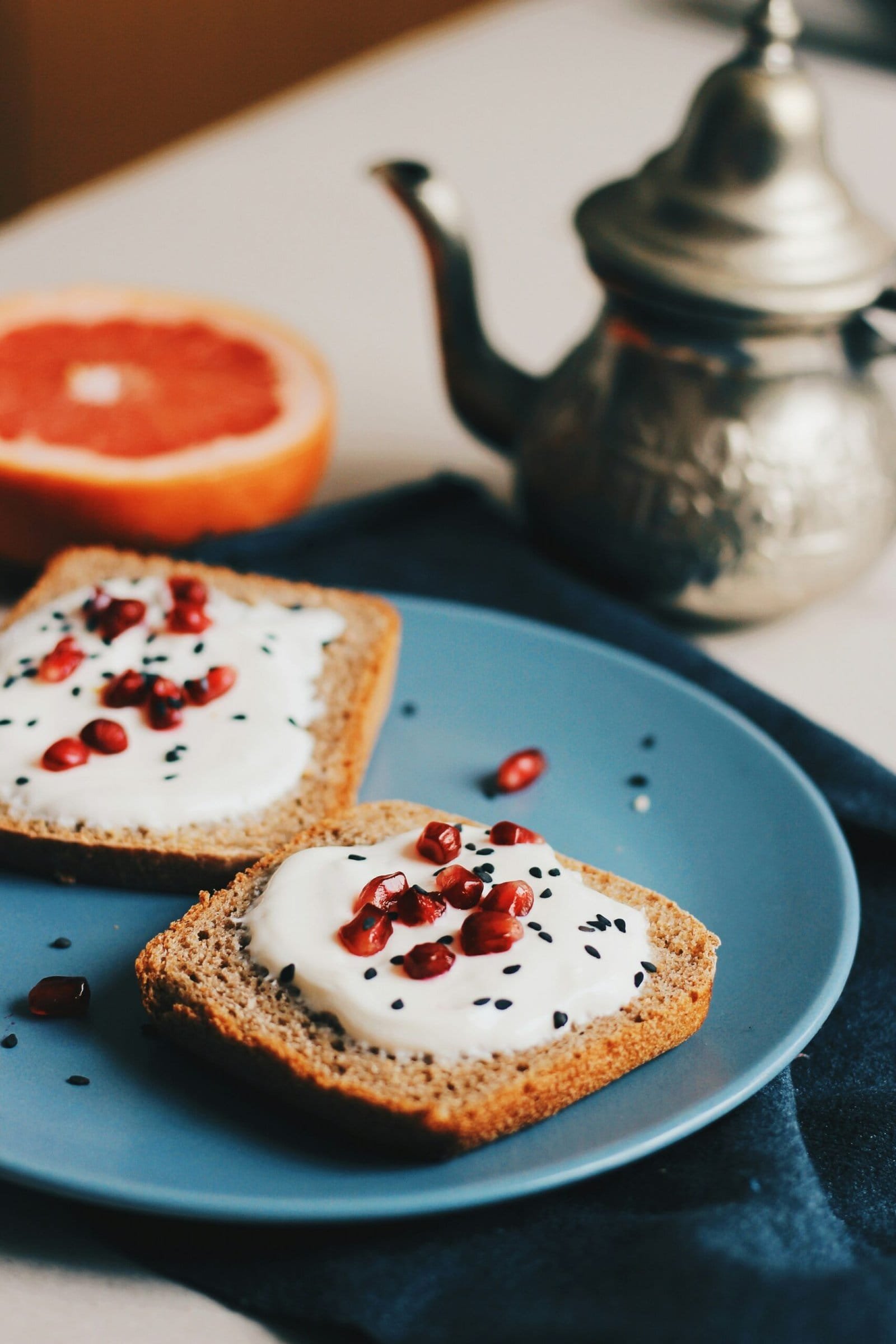 flatlay photography of spreaded bread beside teapot