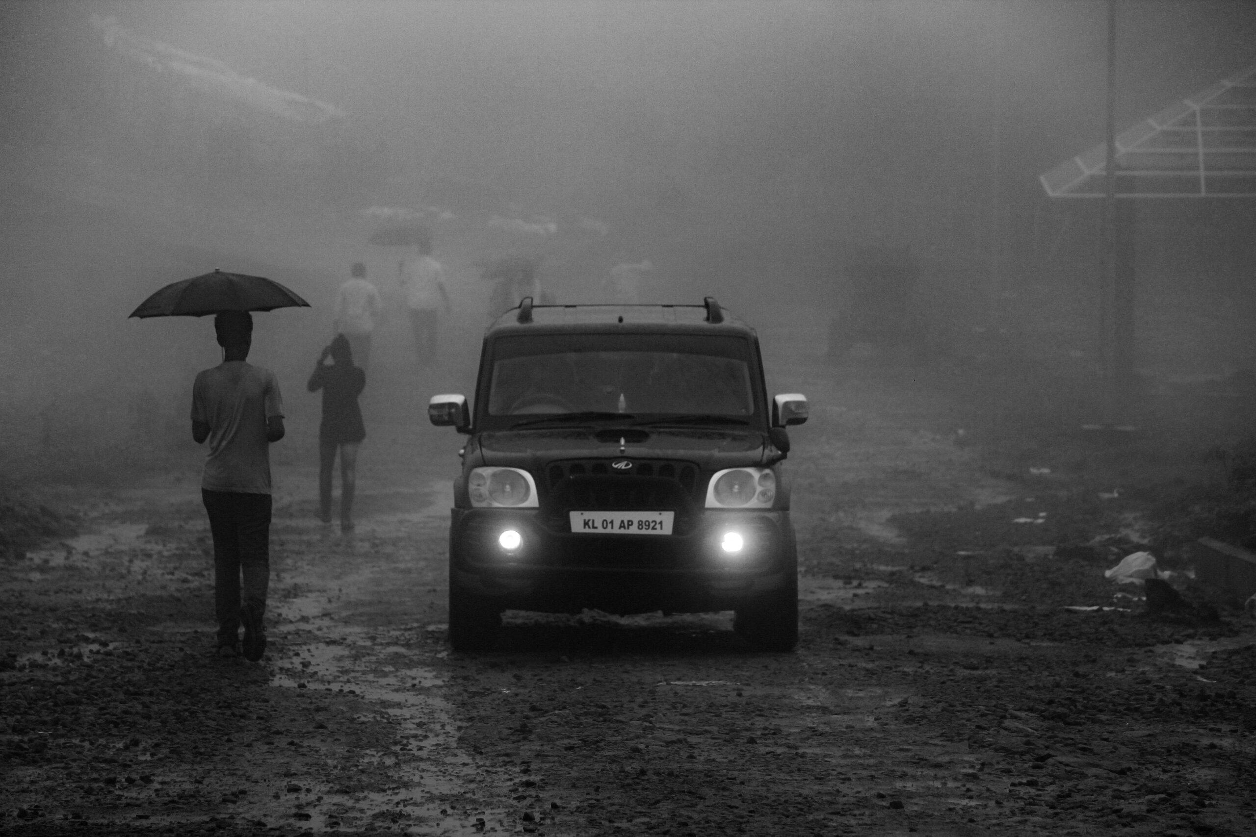 grayscale photo of black car on road