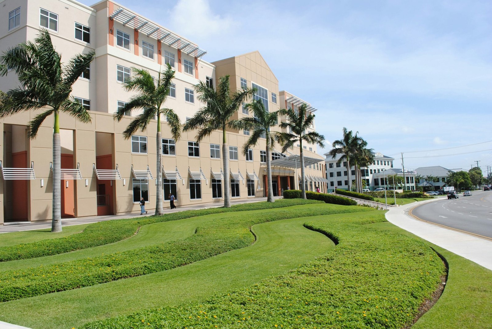 green grass field near brown concrete building during daytime