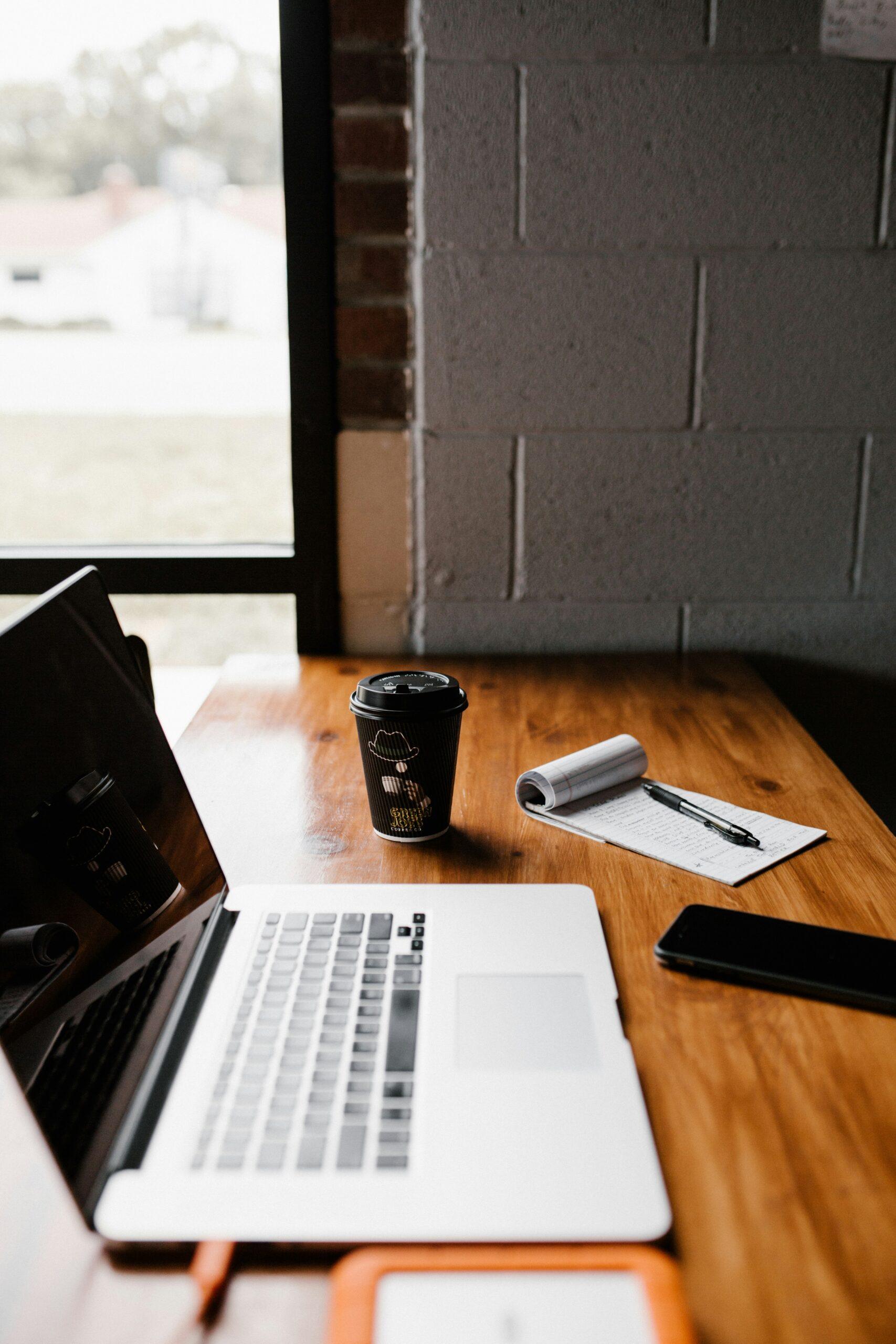 laptop on table near cup