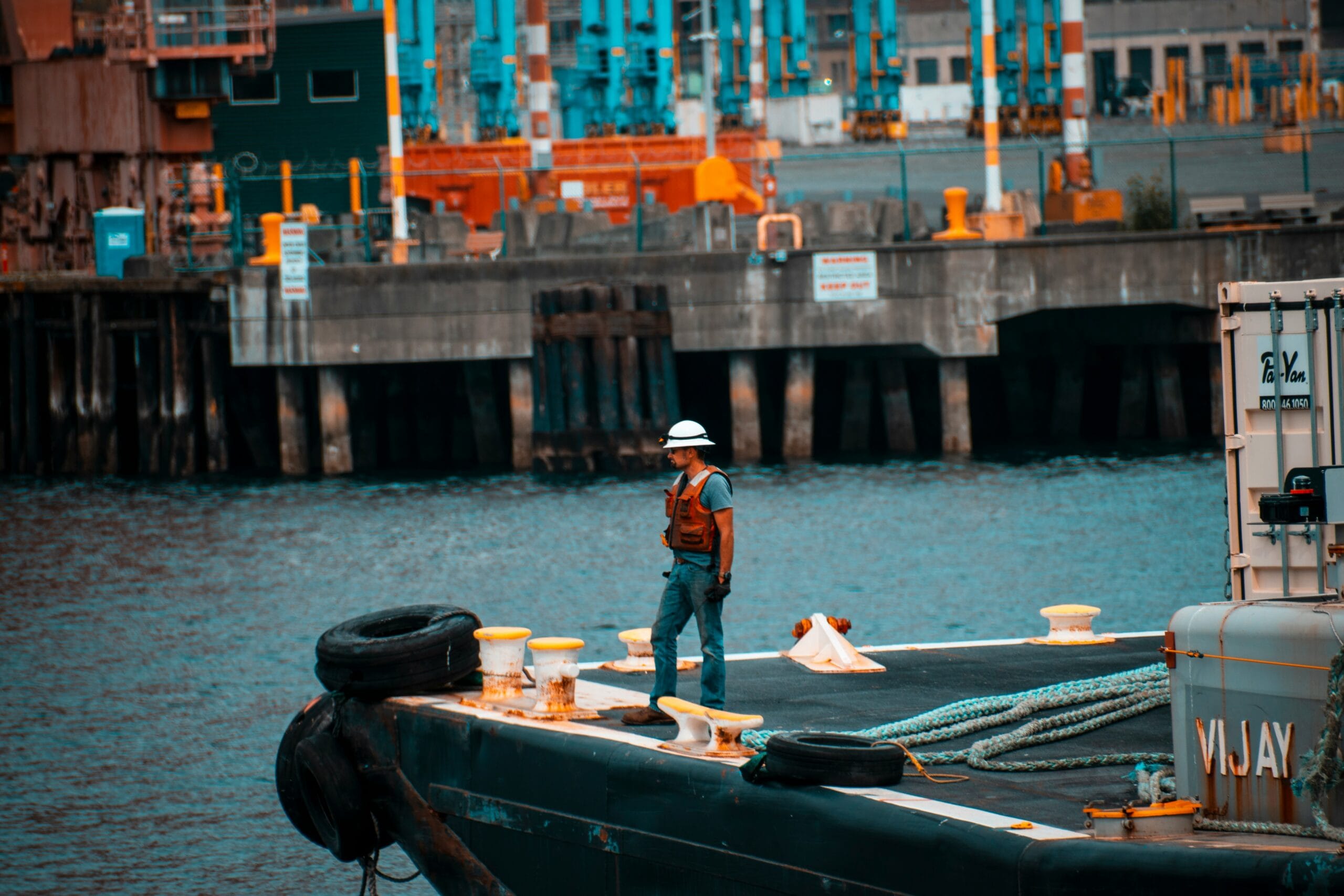 man standing on sailboat