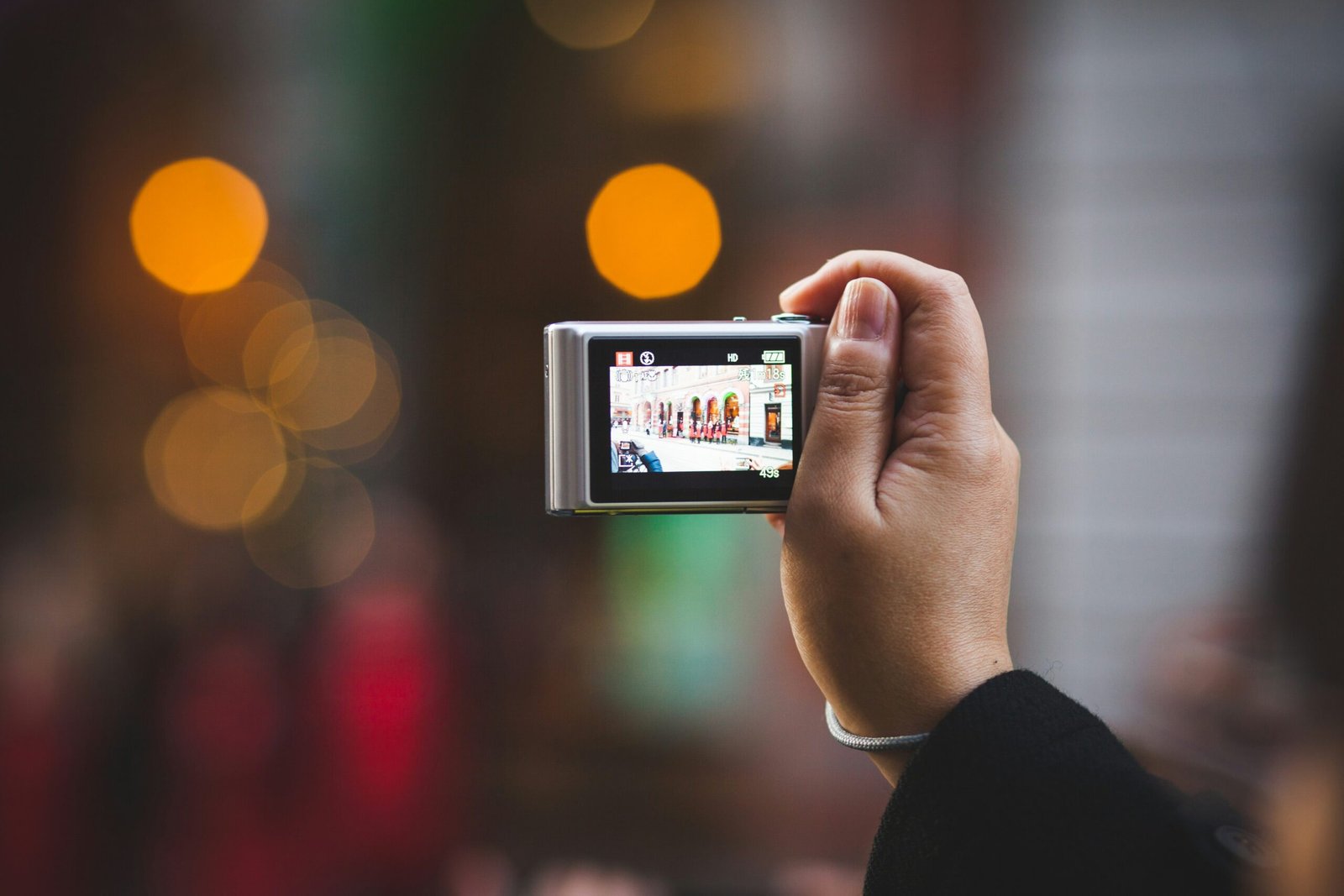 person holding digital camera