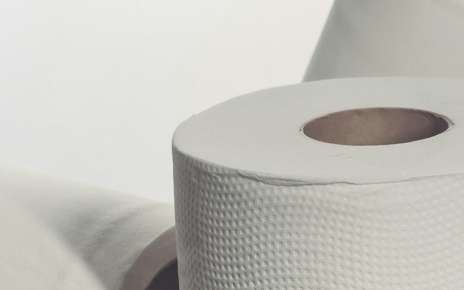 white toilet paper roll on white table