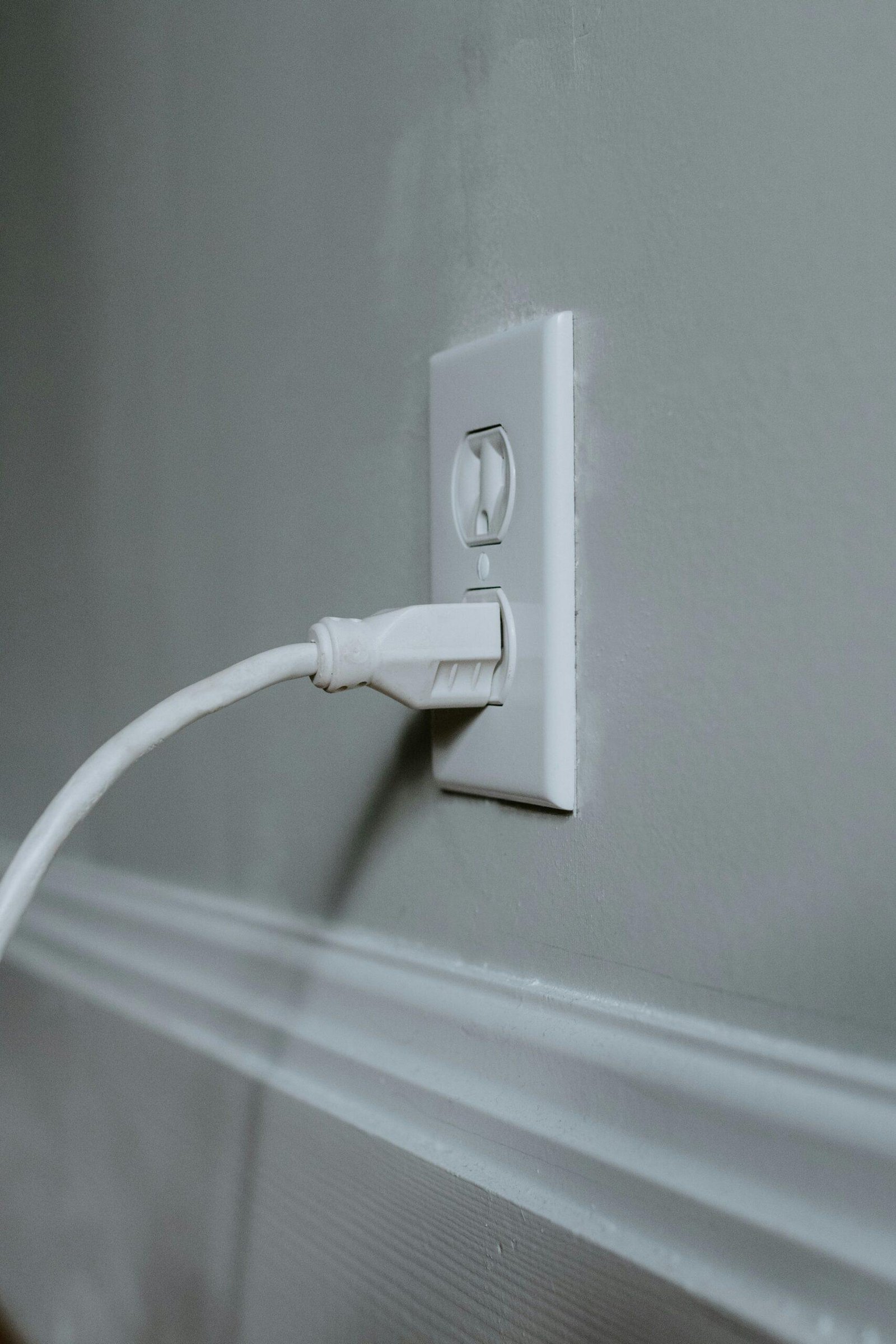 white usb cable plugged in white electric socket