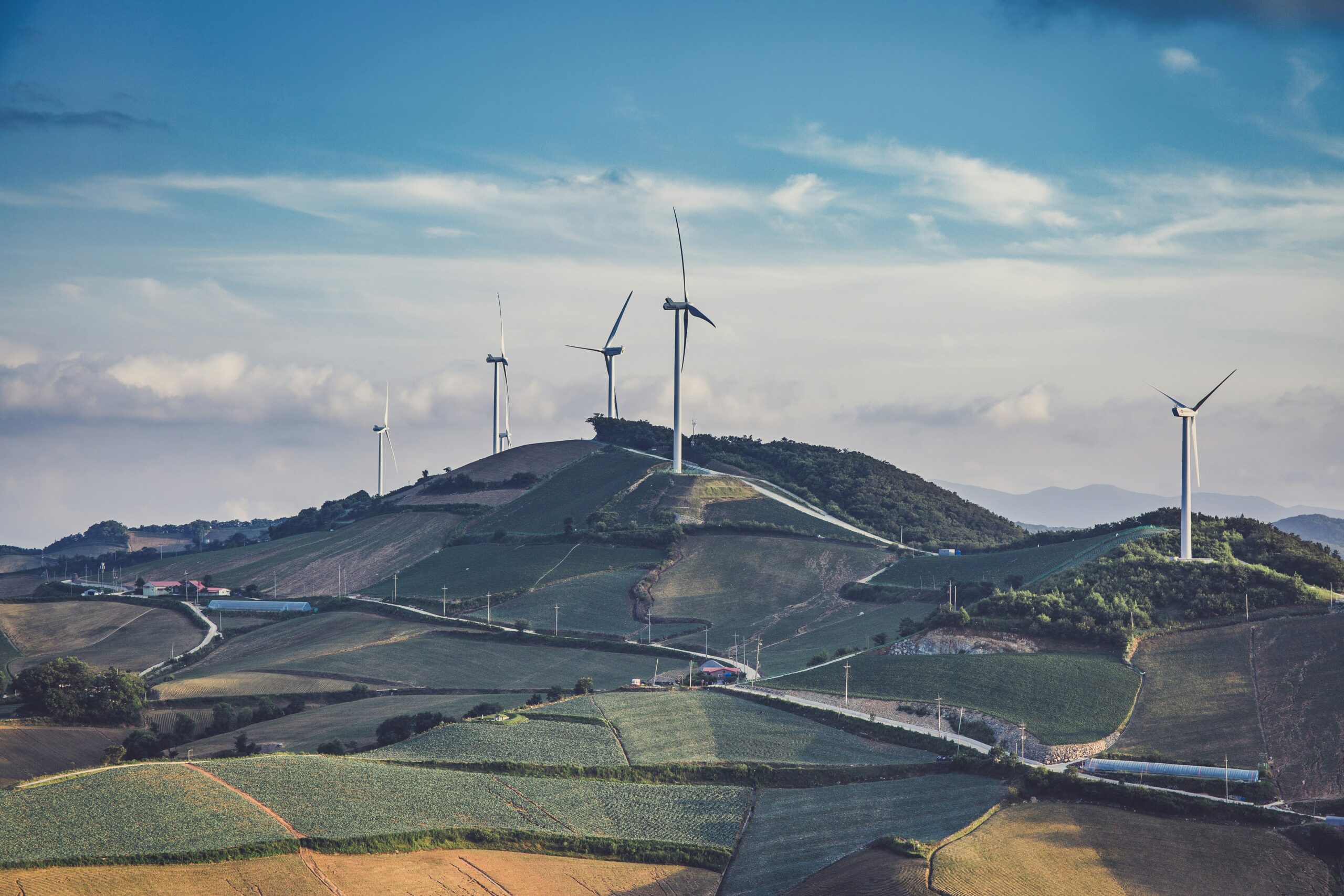 white windmills on top of mountain at daytime